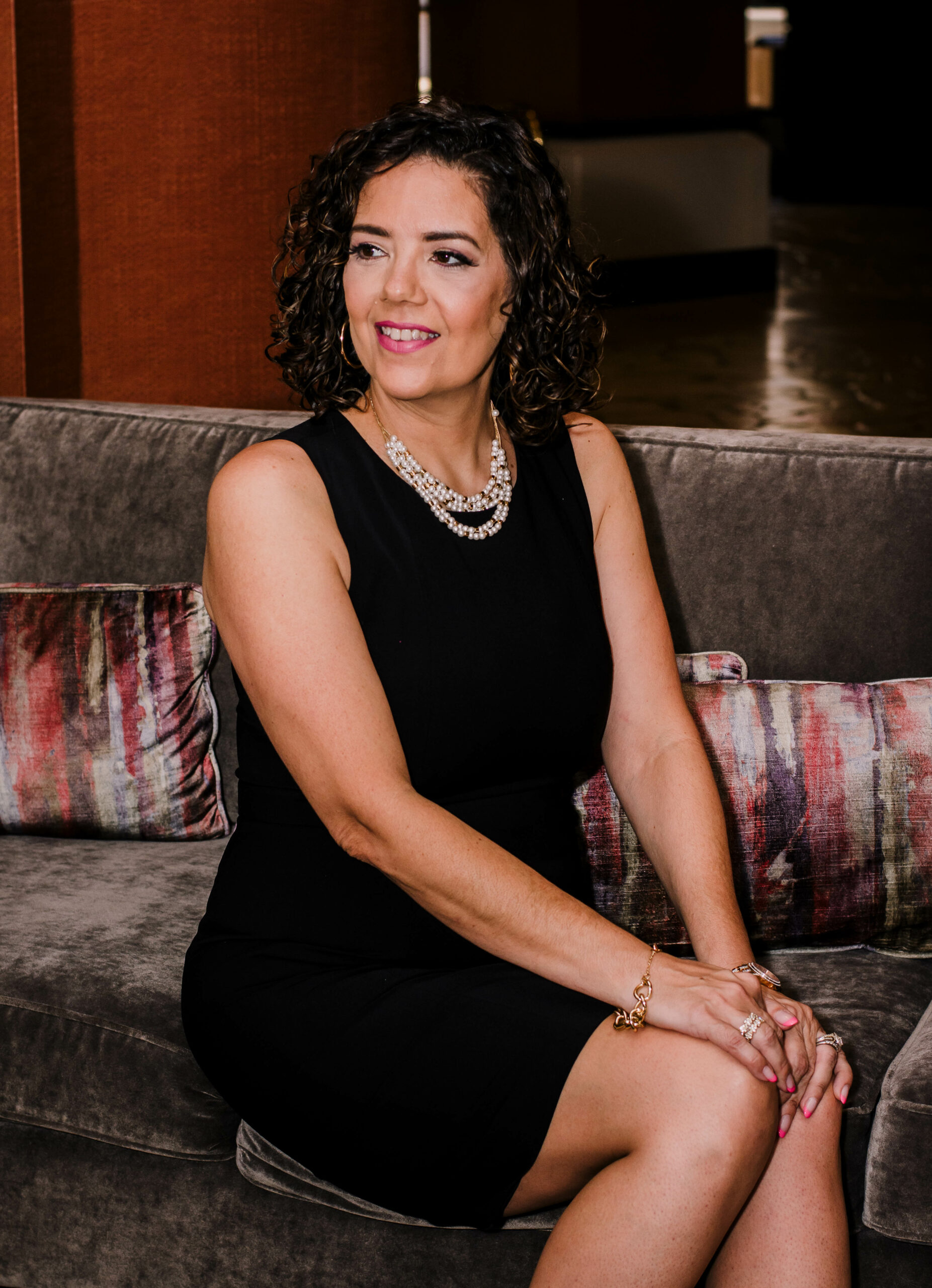 Portrait of Nancy Brown in a professional black dress, exuding confidence and expertise. This image represents the professionalism and competence of our business coaching services.